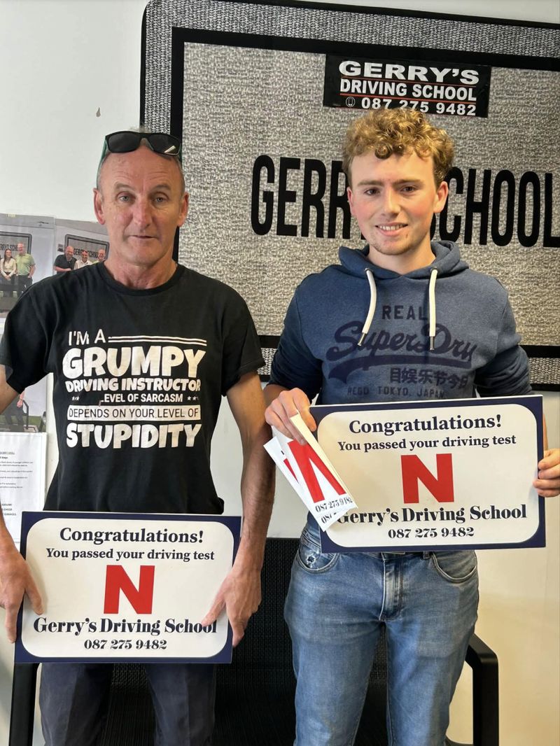 Patrick celebrating his first-time driving test pass with Gerry